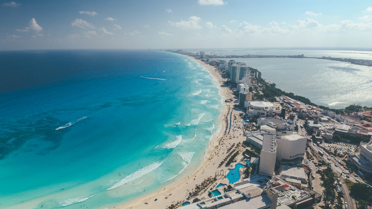 gallery-3 Breathtaking aerial photograph capturing Cancun's clear blue waters and vibrant cityscape.